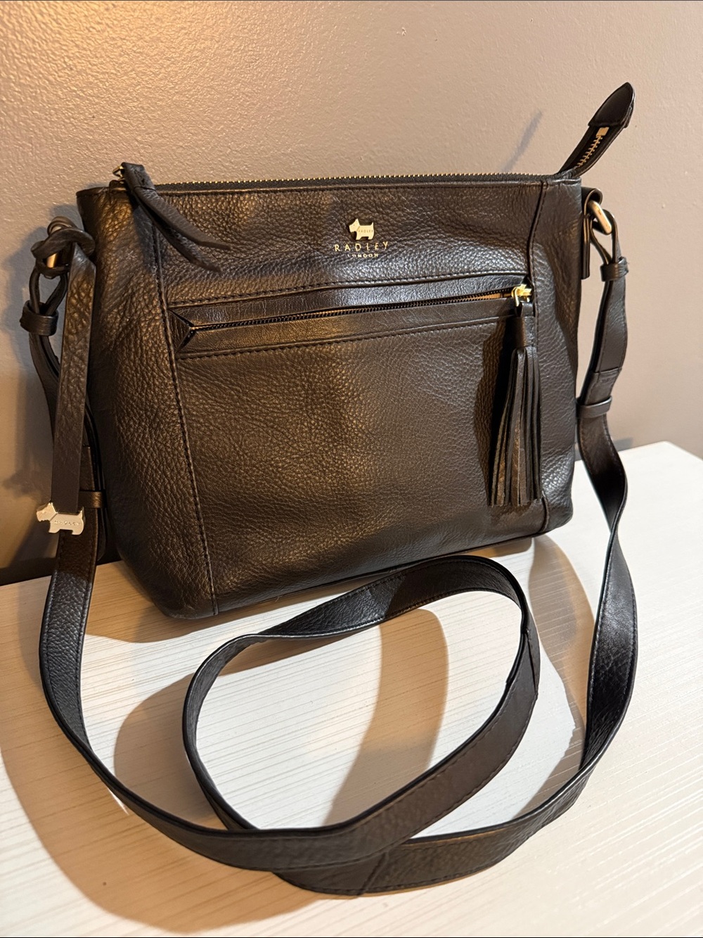 RADLEY London. Black leather. Has rubbing on the corners.